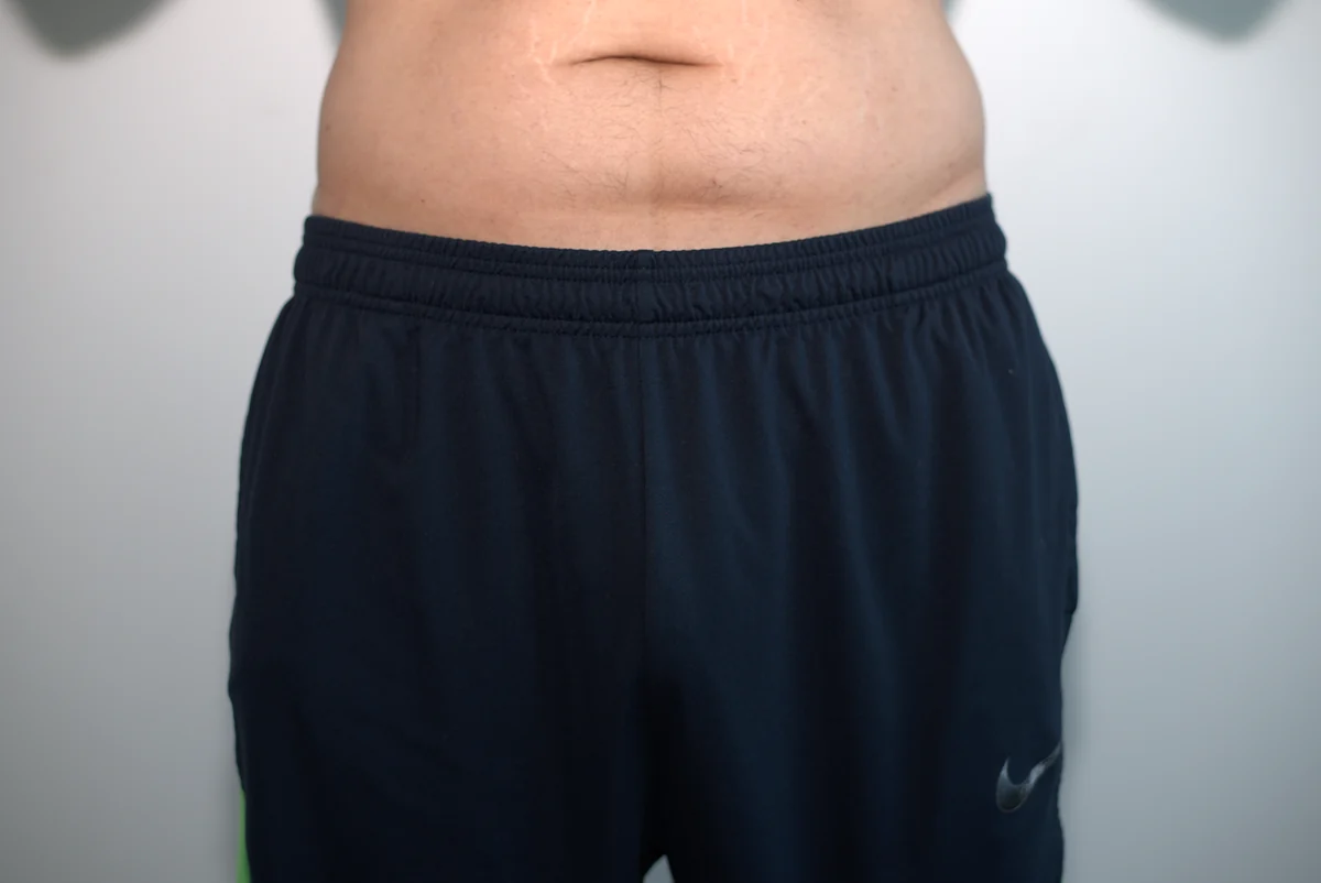 Front view of dark gym shorts worn over the AWRY APEX Jock Thong.