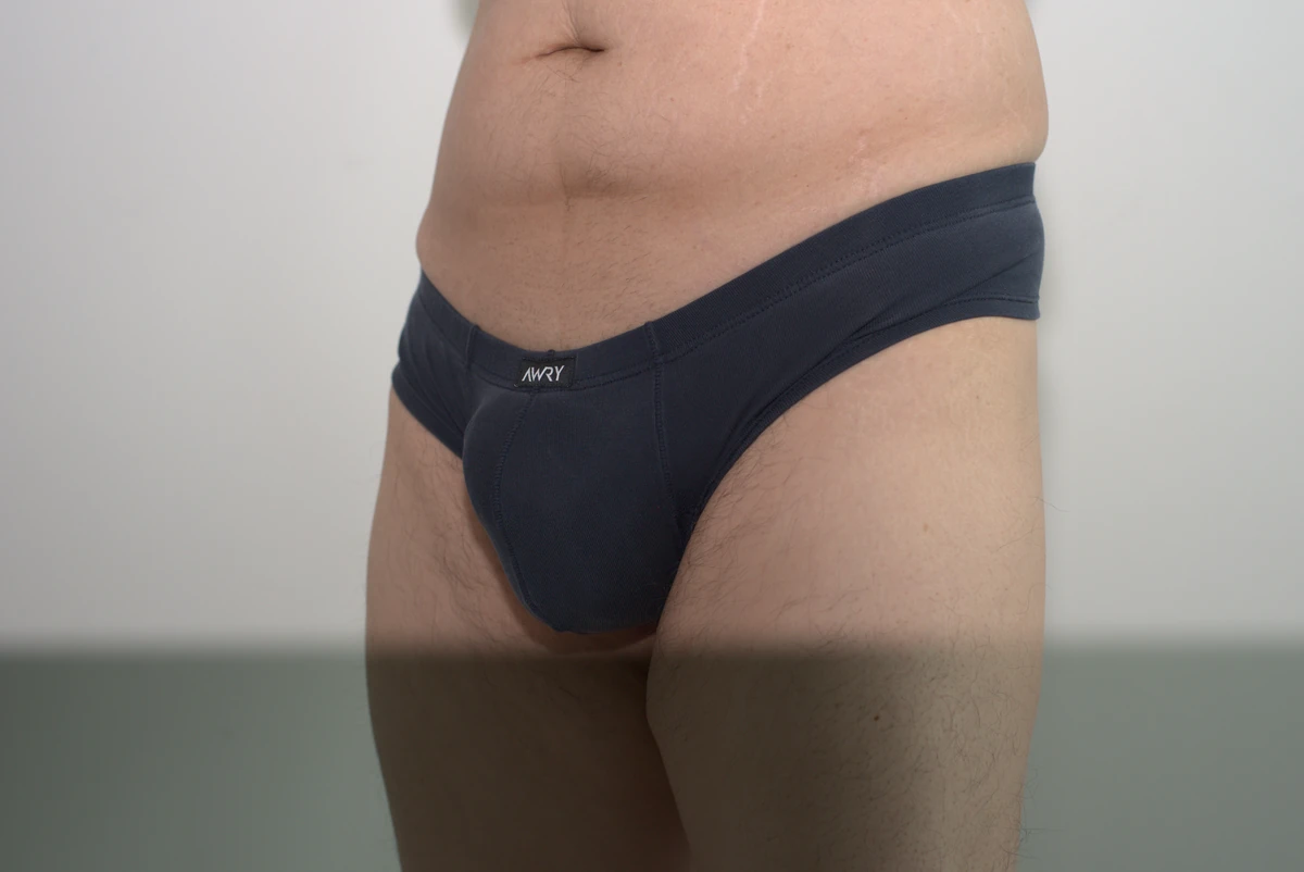 Navy AWRY CHEEKY Thong V2 in Medium: Front three-quarter view showing the pouch profile and transition into the side fabric.