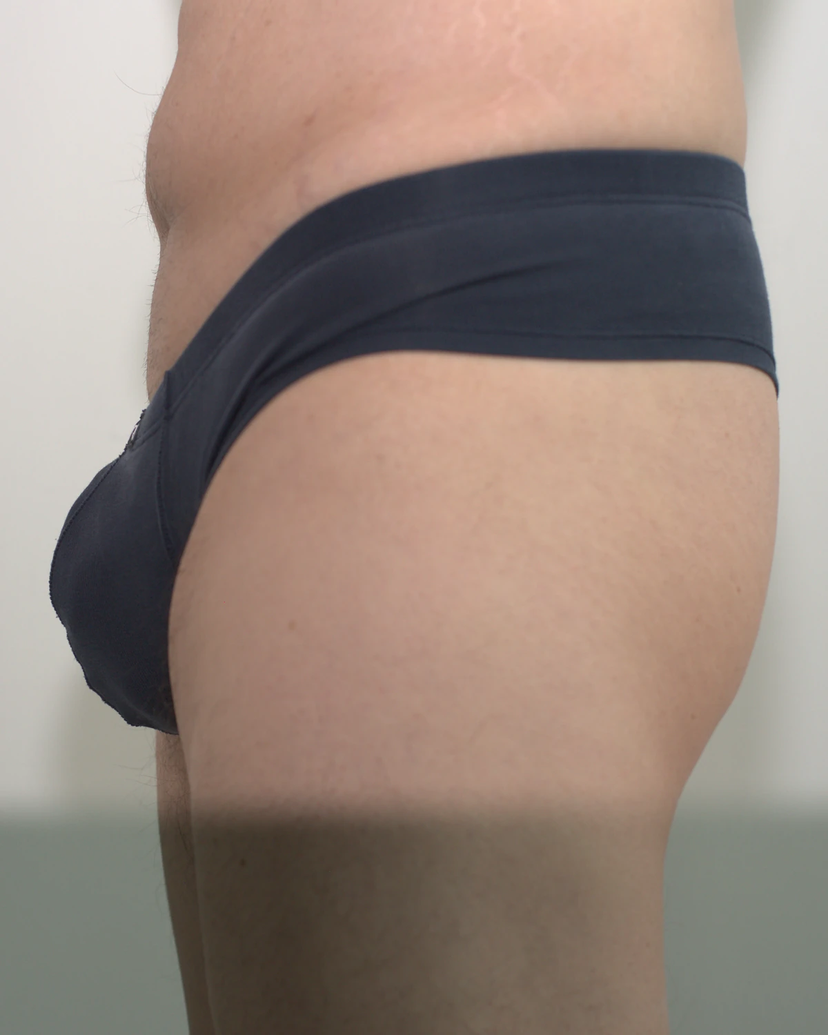 Navy AWRY CHEEKY Thong V2 in Medium: Side view showing the pouch profile and side coverage.