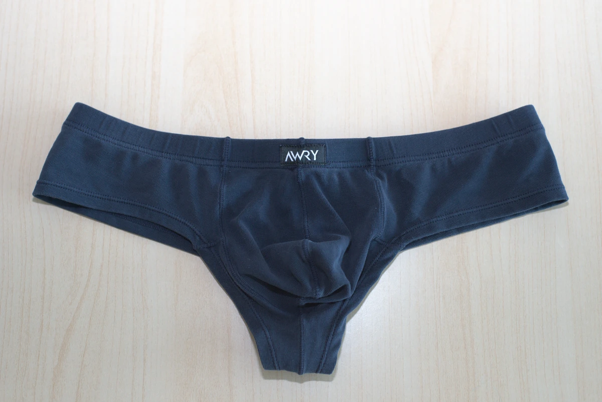 Navy AWRY CHEEKY Thong V2 in Medium: Full front flat lay of the Navy pair, showing the pouch and wider sides.