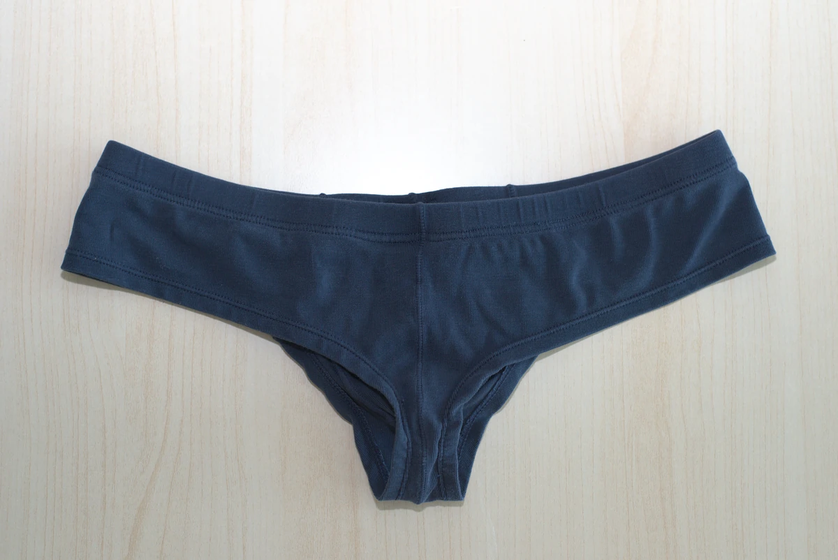 Navy AWRY CHEEKY Thong V2 in Medium: Full rear flat lay showing the cheeky cut and tail.