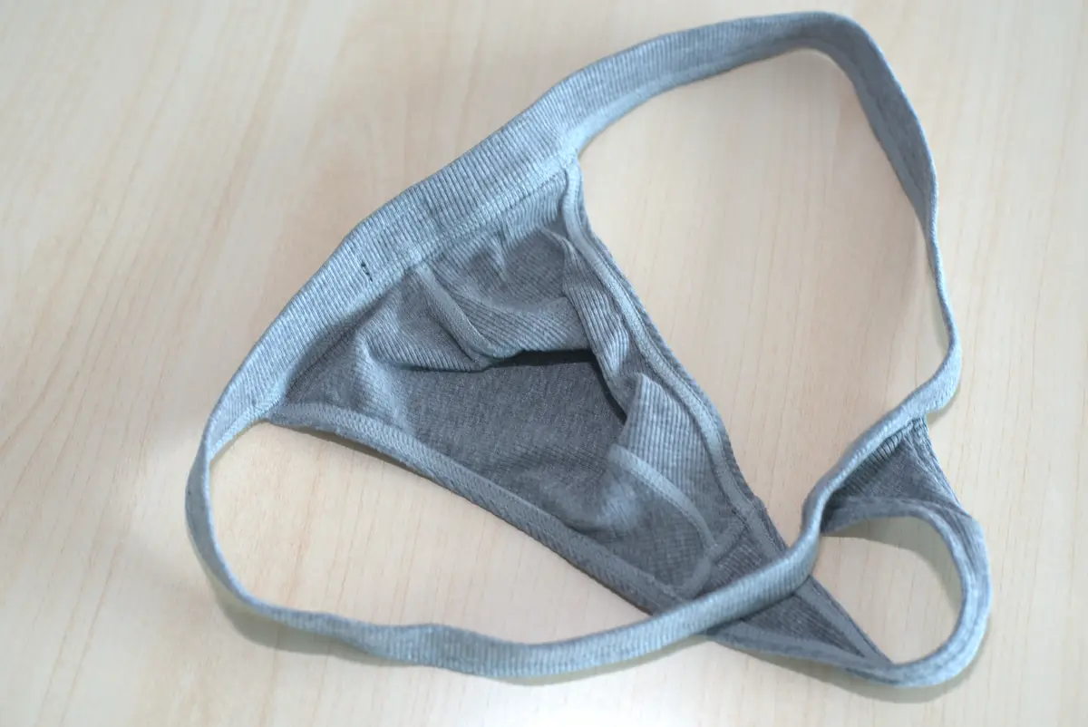 Interior construction of the heather gray AWRY RIBBED Thong, showing the pouch panel, seams, and edge binding.