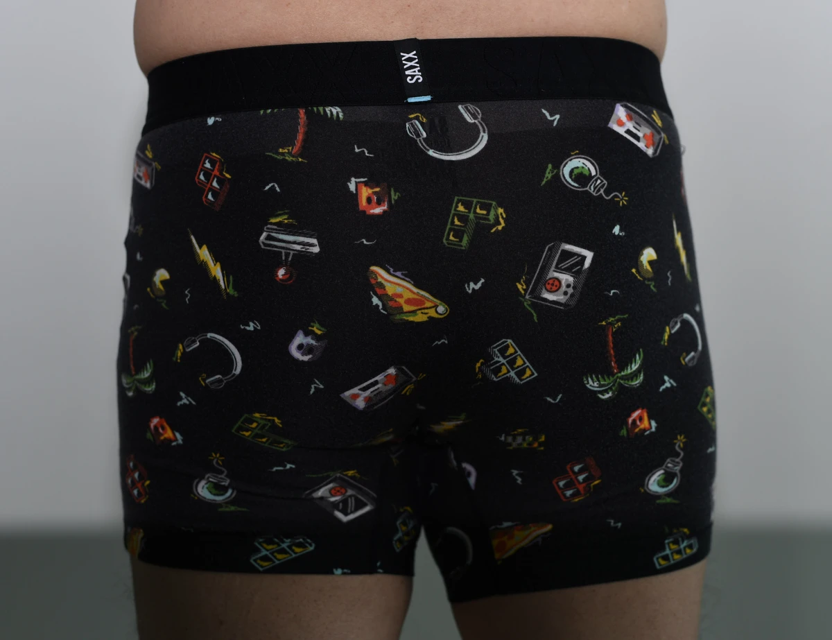 Rear view of the black patterned SAXX boxer brief, showing the seat, waistband and both leg hems.