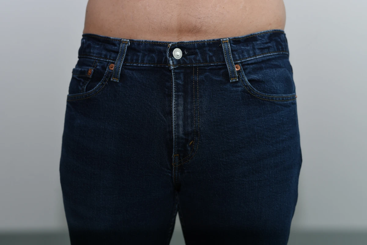 Wider front view of jeans worn over the SAXX boxer brief, with both clothing edges visible.
