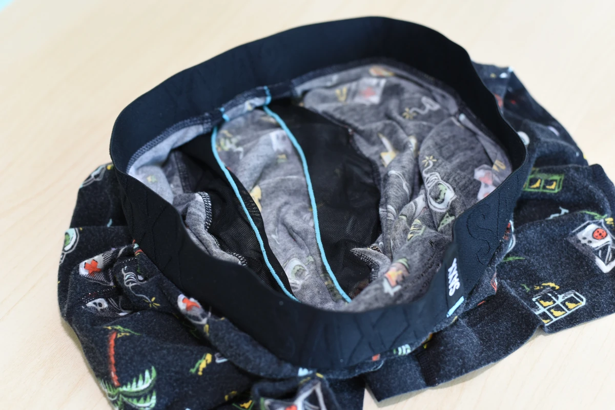 Interior of the SAXX boxer brief with two black mesh separator panels and contrasting light-blue edging.